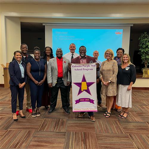 principals from all schools stand with alabama purple star school program banner