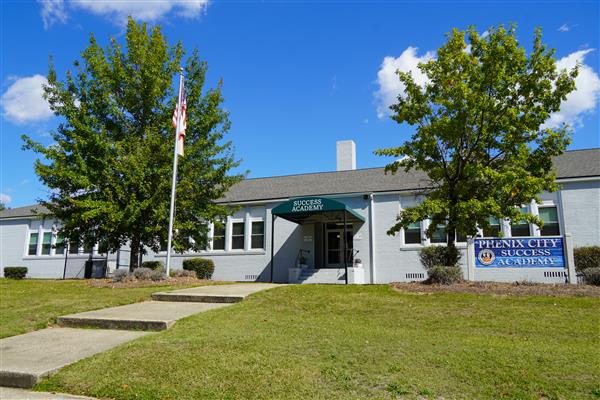 photo is of the front door and sign of the success academy 